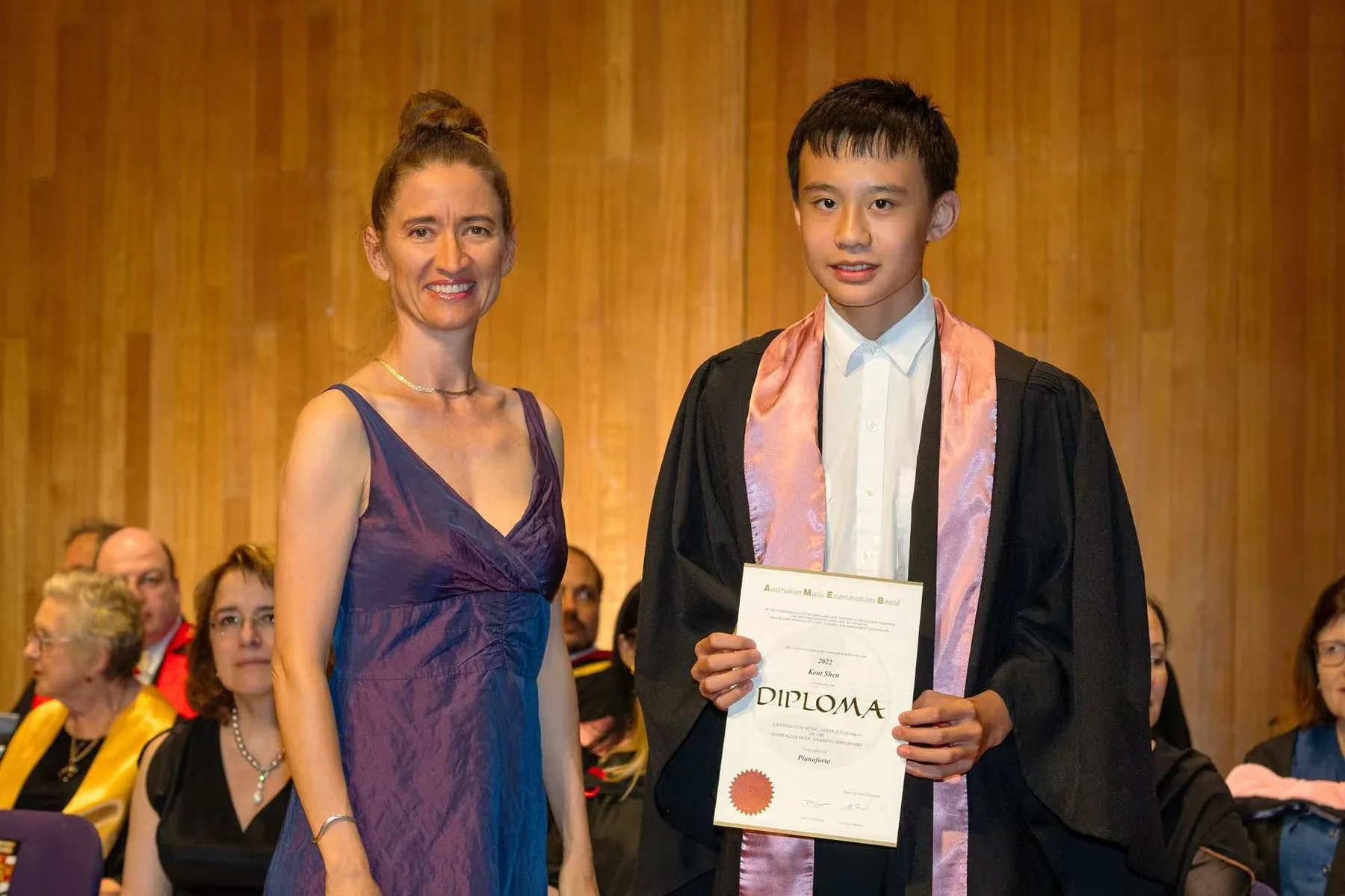 Kent holding his AMEB piano diploma